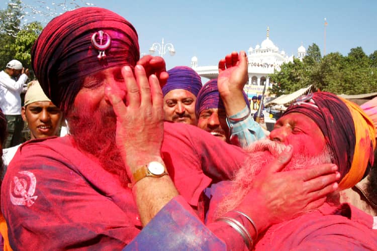 On the day of Holi, people in Anandpur Sahib are enjoying each other's colors